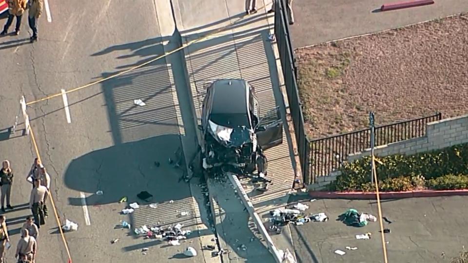 Investigators gather near an SUV that struck Los Angeles County sheriff’s recruits in the suburb of Whittier on 16 November 2022 (AP)