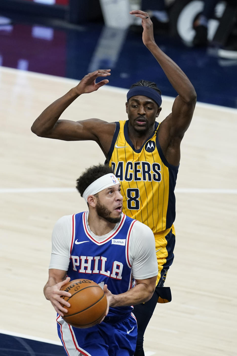 Philadelphia 76ers' Seth Curry (31) goes goes to the basket against Indiana Pacers' Justin Holiday (8) during the first half of an NBA basketball game, Tuesday, May 11, 2021, in Indianapolis. (AP Photo/Darron Cummings)