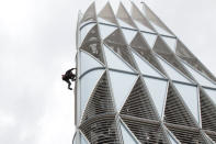 French climber Alain Robert, also known as "Spiderman", scales the 231 metre First Tower at the La Defense business district outside Paris May 10, 2012. REUTERS/Benoit Tessier