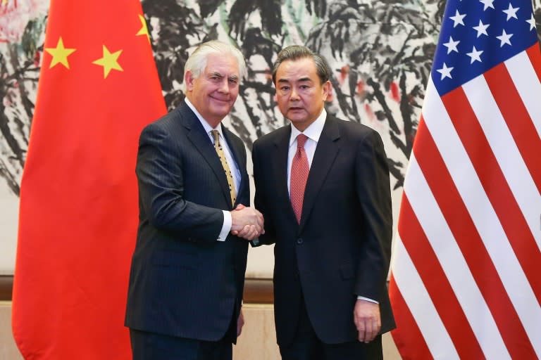 China's Foreign Minister Wang Yi (right) shakes hands with US Secretary of State Rex Tillerson after a joint press conference in Beijing, on March 18, 2017