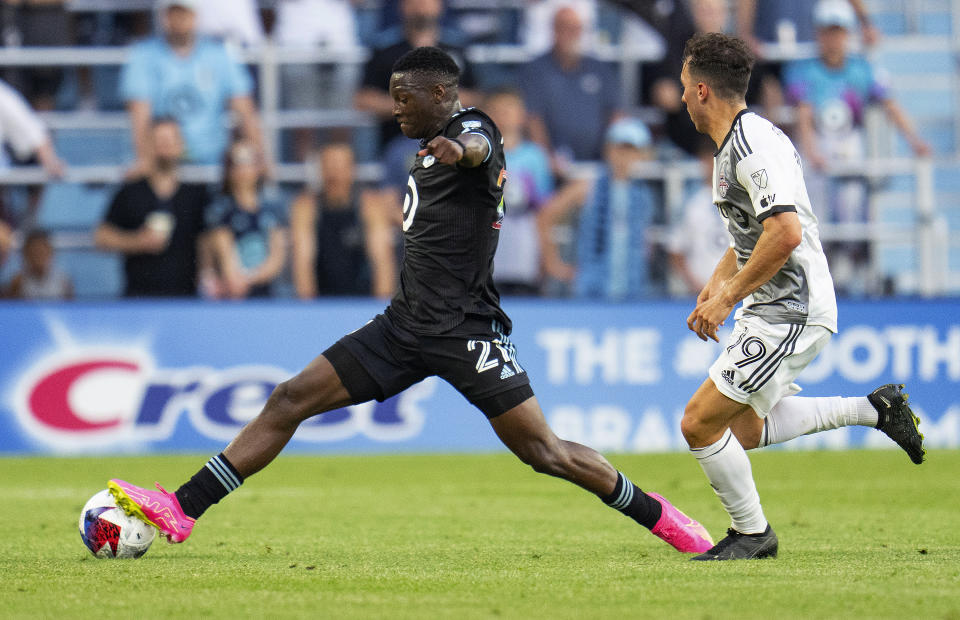 Minnesota United forward Bongokuhle Hlongwane (21) kicks the ball away from Toronto FC midfielder Kobe Franklin (19) during the first half of an MLS soccer match Saturday, June 3, 2023, in St. Paul, Minn. (Alex Kormann/Star Tribune via AP)