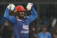 Afghanistan's Gulbadin Naib celebrates after scoring 50 runs during the second T20 cricket match between India and Afghanistan in Indore, India, Sunday, Jan. 14, 2024. (AP Photo/ Rajanish Kakade)
