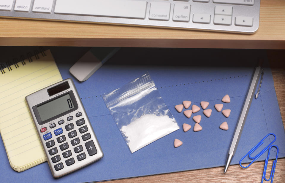 Open office draw with cocaine and ecstasy pills alongside office stuff