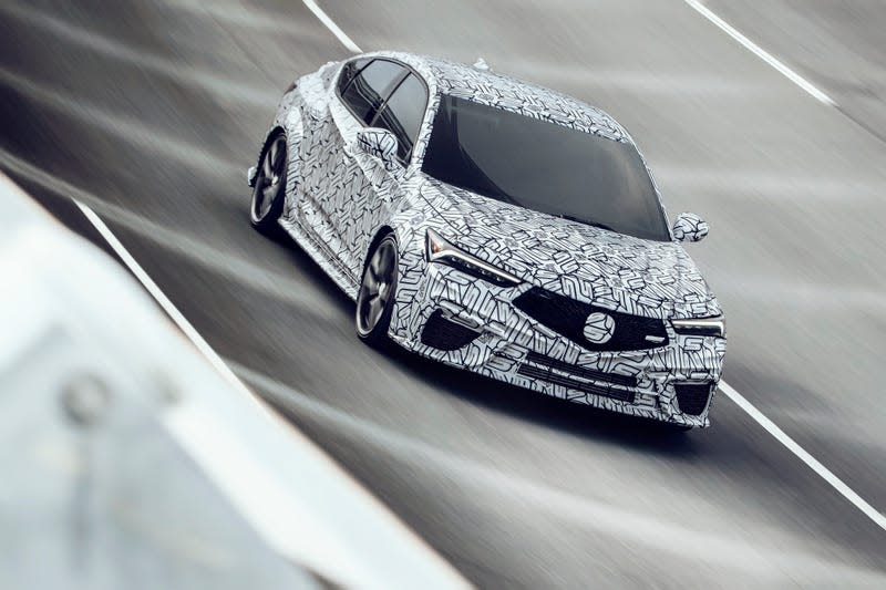 a 2024 acura integra type s prototye wrapped in black and white camouflage drives on a banked race track