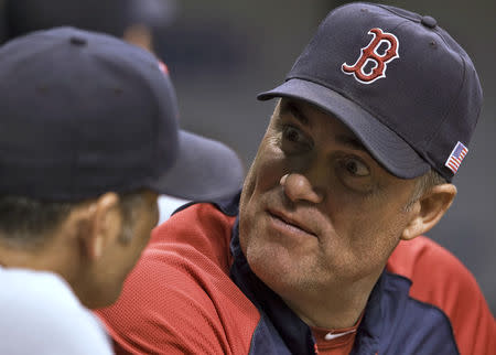 Boston Red Sox manager John Farrell (R) talks with bench coach Torey Lovullo (L) in the dugout during the first inning of their MLB American League baseball game against the Tampa Bay Rays in St. Petersburg, Florida, September 11, 2013. REUTERS/Steve Nesius