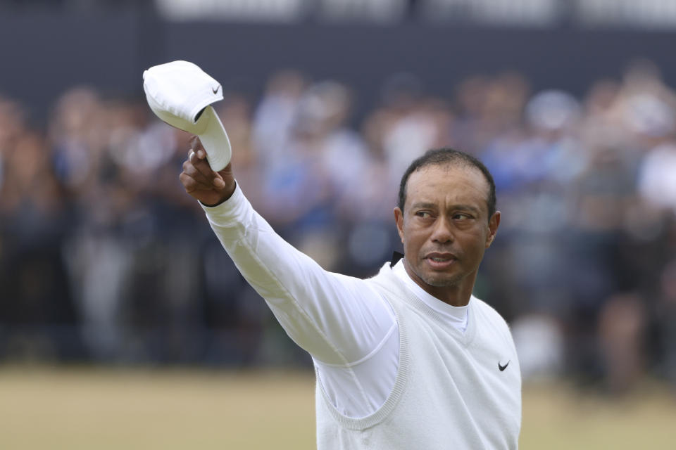 Tiger Woods of the US gestures to the crowd at the end of his second round of the British Open golf championship on the Old Course at St. Andrews, Scotland, Friday July 15, 2022. The Open Championship returns to the home of golf on July 14-17, 2022, to celebrate the 150th edition of the sport's oldest championship, which dates to 1860 and was first played at St. Andrews in 1873. (AP Photo/Peter Morrison)