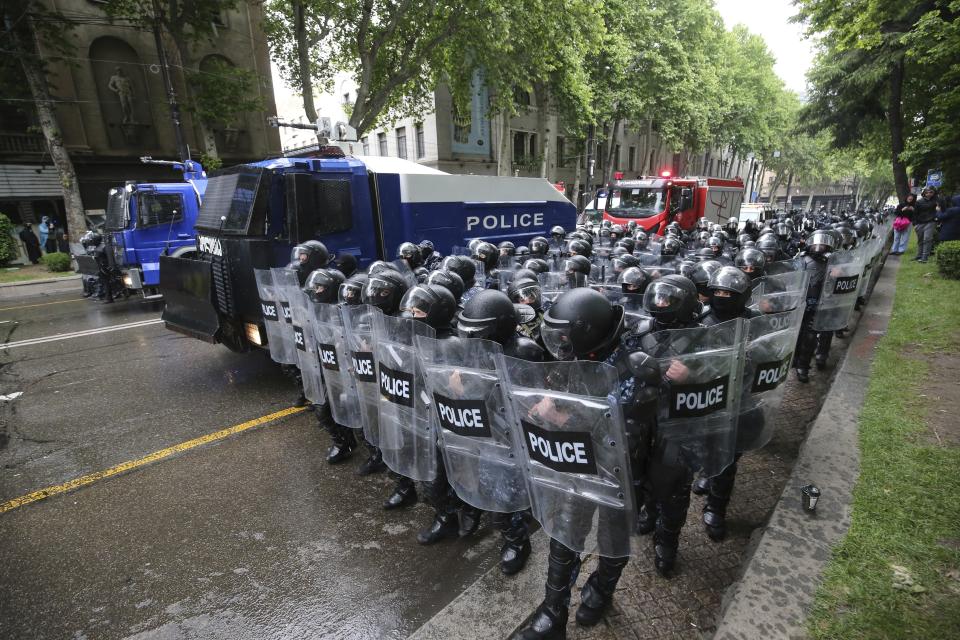Riot police block a street to prevent demonstrators during an opposition protest against "the Russian law" near the Parliament building in the center of Tbilisi, Georgia, Tuesday, May 14, 2024. The Georgian parliament on Tuesday approved in the third and final reading a divisive bill that sparked weeks of mass protests, with critics seeing it as a threat to democratic freedoms and the country's aspirations to join the European Union. (AP Photo/Zurab Tsertsvadze)