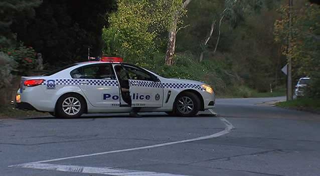 A police road block in the Adelaide foothills. Police have not revealed where the house is located. Photo: 7News.