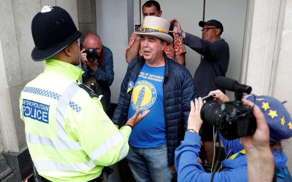 Police speak to Steve Bray, after his loudspeakers were confiscated this week - Peter Nicholls/Reuters