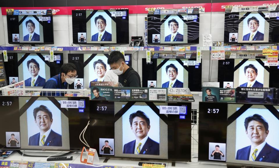 TV screens show the news programs reporting the state funeral for former Japanese Prime Minister Shinzo Abe, in Fukuoka, western Japan, on Tuesday, Sept. 27, 2022. (Kyodo News via AP)