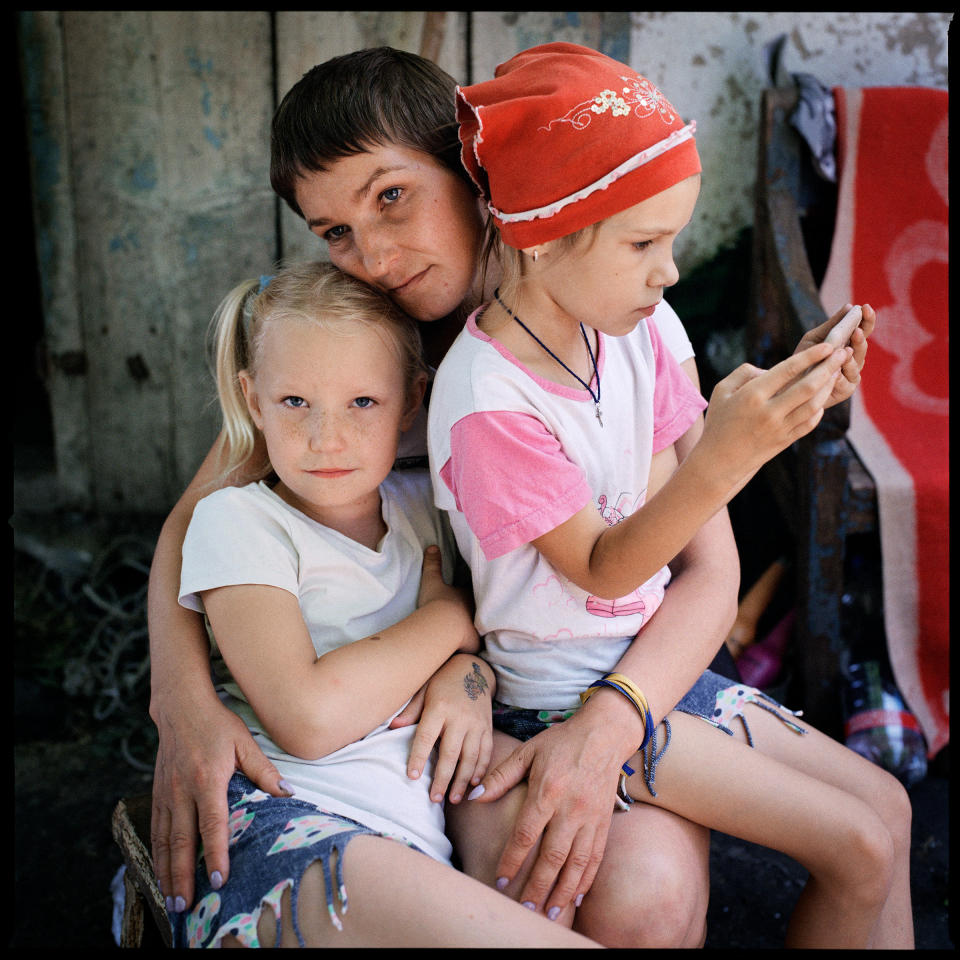 Olga Grinik, her daughter Miroslava, left, and her niece's daughter Angelina Drobysh, right, in Poltava region, where the family fled to escape the war, on June 29, 2022. Avdiivka, the Grinik family's hometown, has seen fierce fighting. The family recently learned that their house has been destroyed, along with much of the town.<span class="copyright">Anastasia Taylor-Lind</span>