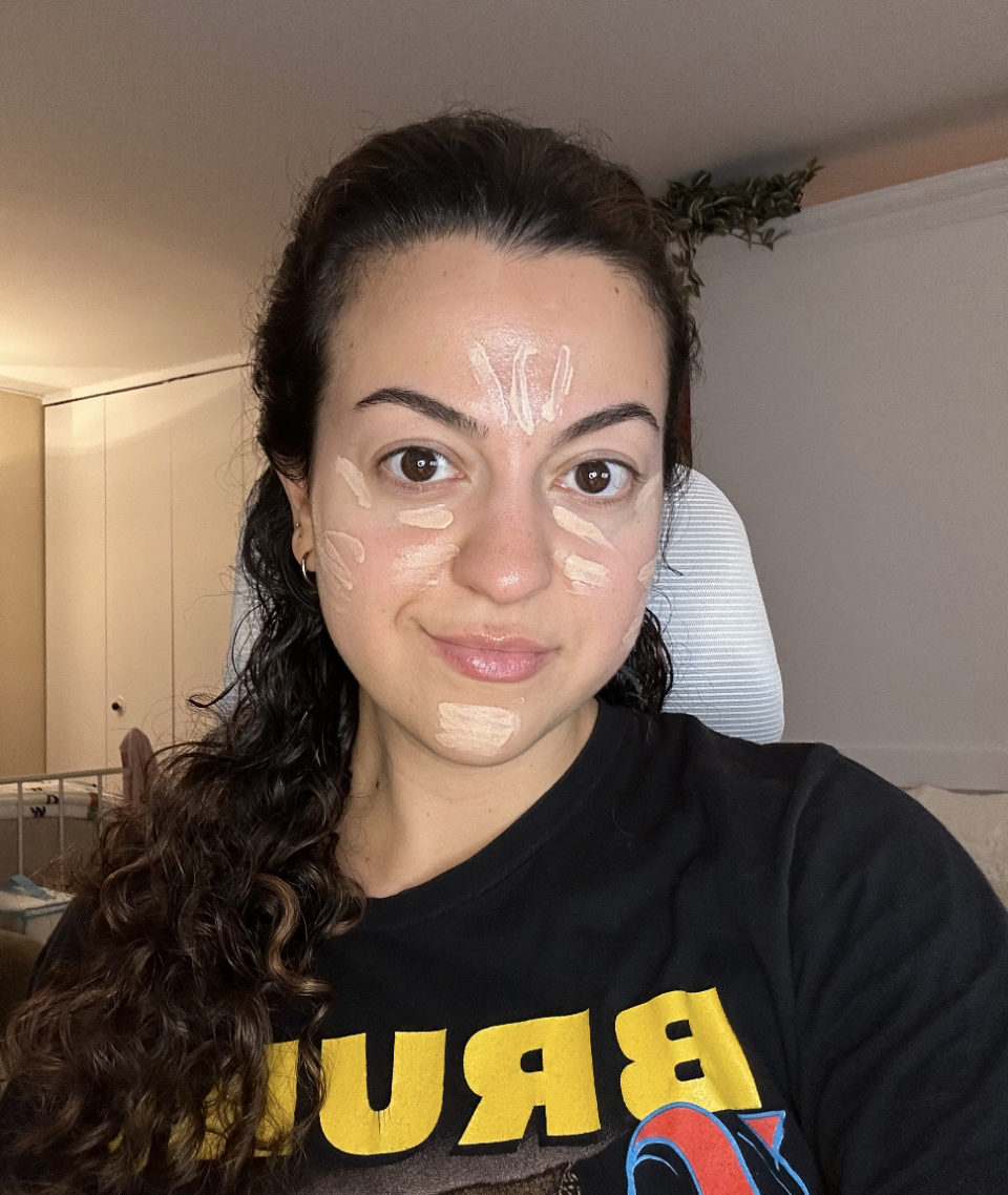 the author posing with concealer on her face