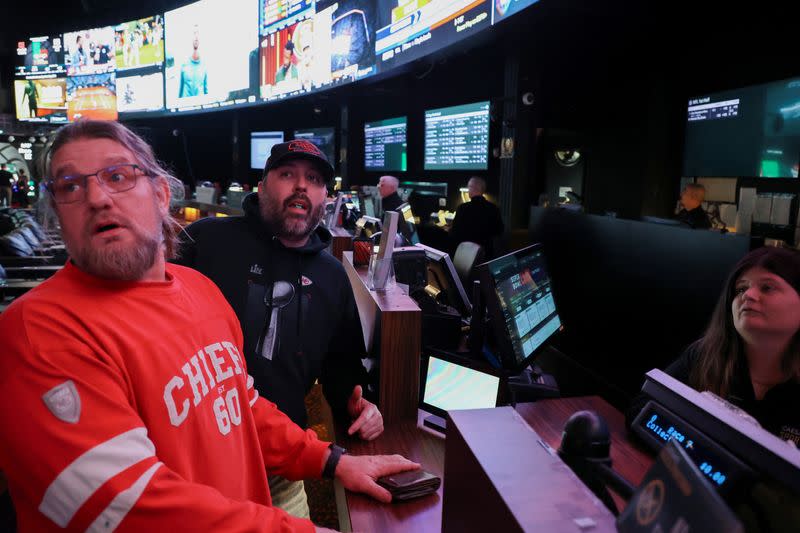 Ernie McCush looks at television screens in the sportsbook area of Caesars Palace