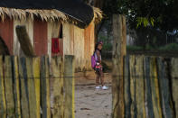 A Indigenous Tembe girl walks to school at dawn in the Tenetehar Wa Tembe village in the Alto Rio Guama Indigenous territory, in Paragominas municipality, in Para state, Brazil, Tuesday, May 30, 2023. (AP Photo/Eraldo Peres)