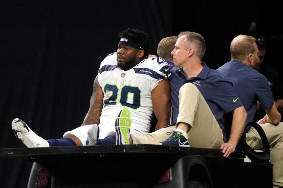 Seattle Seahawks running back Rashaad Penny is carted off the field during an NFL football game against the New Orleans Saints in New Orleans, Sunday, Oct. 9, 2022. (AP Photo/Gerald Herbert)