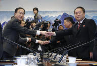 South Korean Unification Minister Cho Myoung-gyon, left, shakes hands with his North Korean counterpart Ri Son Gwon during their meeting at the southern side of Panmunjom in the Demilitarized Zone, South Korea, Monday, Oct. 15, 2018. The rival Koreas are holding high-level talks Monday to discuss further engagement amid a global diplomatic push to resolve the nuclear standoff with North Korea. (Korea Pool/Yonhap via AP)