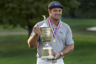 Bryson DeChambeau, of the United States, holds up the winner's trophy after winning US Open Golf Championship, Sunday, Sept. 20, 2020, in Mamaroneck, N.Y. (AP Photo/John Minchillo)