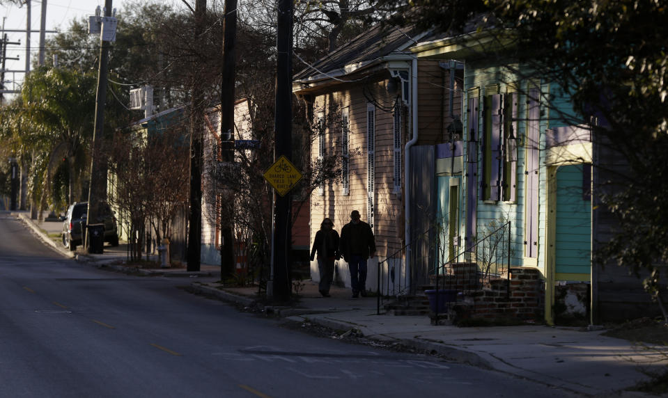 FILE- In this Feb. 13, 2015 file photo, pedestrians walk along Chartres St. near the Mississippi River waterfront in the Bywater section of New Orleans. A New Orleans City Council member has released a long-awaited proposal that would ban short-term rentals of whole houses in the city's residential areas. Thursday's move by Kristen Gisleson Palmer drew an immediate rebuke from a spokesman from HomeAway, one of the businesses that arranges short-term vacation rentals online. (AP Photo/Gerald Herbert, File)