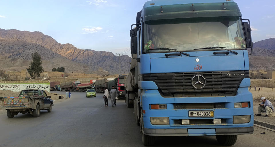 Stranded trucks loaded with supplies for Afghanistan, line up on a highway after Afghan Taliban rulers closed a key border crossing point Torkham, in Landi Kotal, an area in Pakistan's district Khyber along Afghan border, Tuesday, Feb. 21, 2023. The main crossing on the Afghan-Pakistan border remained shut Tuesday for the third straight day, officials said, after Afghanistan's Taliban rulers earlier this week closed the key trade route and exchanged fire with Pakistani border guards. (AP Photo/Qazi Rauf)