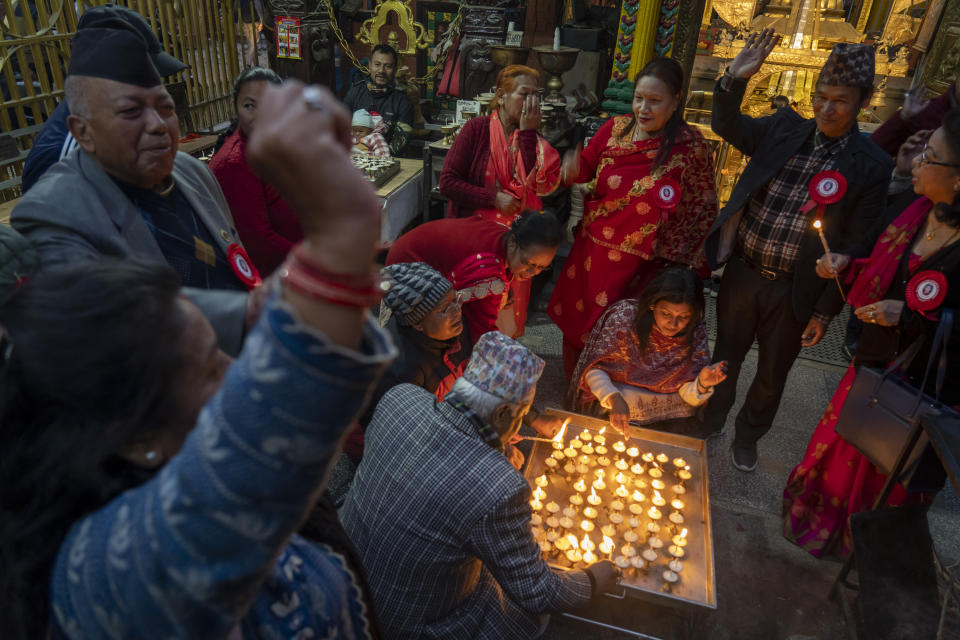Supporters light candles and chant slogans hailing former king Gyanendra and former queen Komal Rajya Laxmi Shah as they celebrate the former queen's birthday in Kathmandu, Nepal, Feb. 29, 2024. Nepal’s once unpopular monarchy — abolished after centuries of rule over the Himalayan nation — is hoping to regain some of its lost glory. Royalist groups and supporters of former King Gyanendra have been holding rallies to demand the restoration of the monarchy and the nation’s former status as a Hindu state. (AP Photo/Niranjan Shrestha)