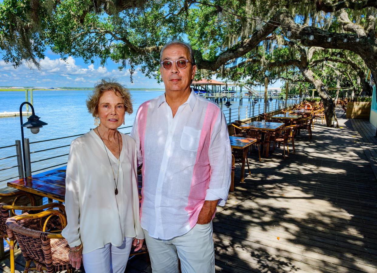 Vivian and Bernard de Raad, owners of Cap's On the Water, stand on the deck restaurant that overlooks the Intracoastal Waterway, north of St. Augustine, on Thursday, Aug. 4, 2022. The restaurant was recently ranked No. 9 among the "15 Most Beautiful Restaurants in the U.S.," according to the travel industry website Tripstodiscover.com. 