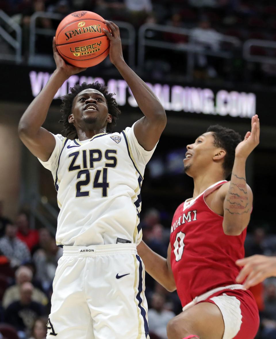 Akron Zips guard Ali Ali (24) shoots over Miami (OH) Redhawks guard Eian Elmer (0) during the first half of an NCAA college basketball game in the quarterfinals of the Mid-American Conference Tournament at Rocket Mortgage FieldHouse, Thursday, March 14, 2024, in Cleveland, Ohio.