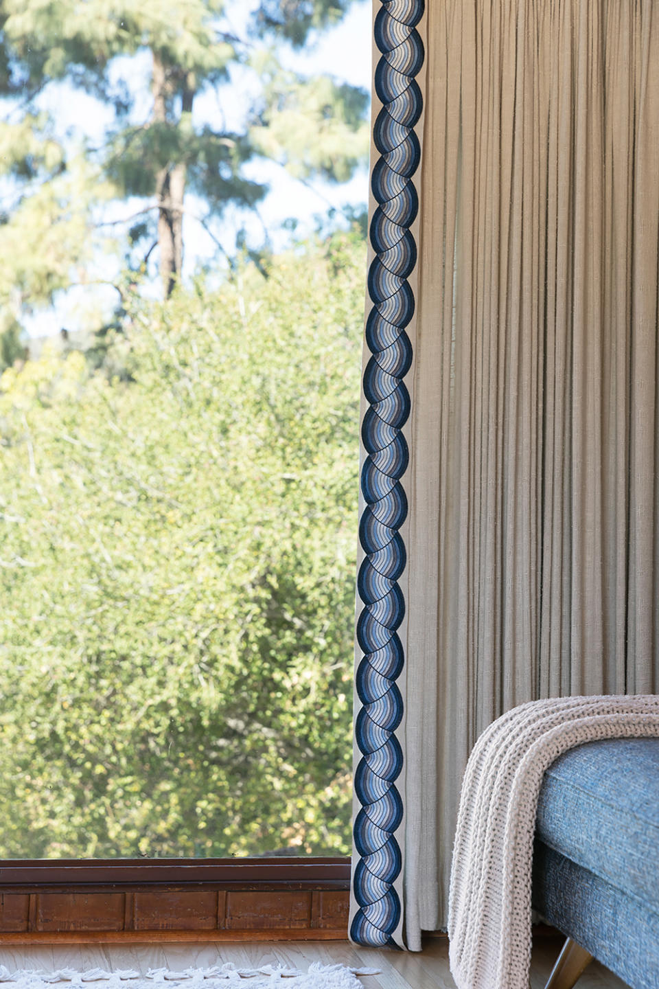 cream curtain with swirly blue trim