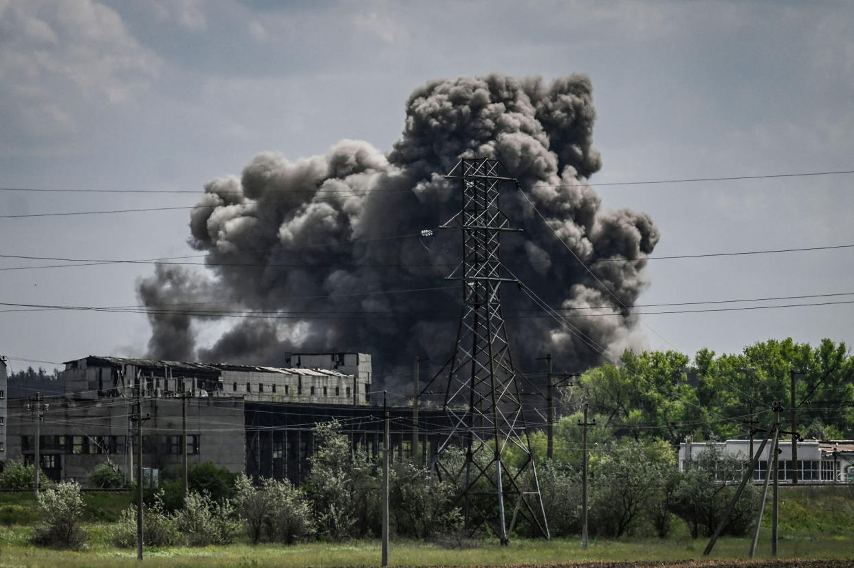 Smoke and dirt ascends after a strike at a factory in the city of Soledar at the eastern Ukranian region of Donbas on May 24, 2022. (Aris Messinis / AFP - Getty Images)