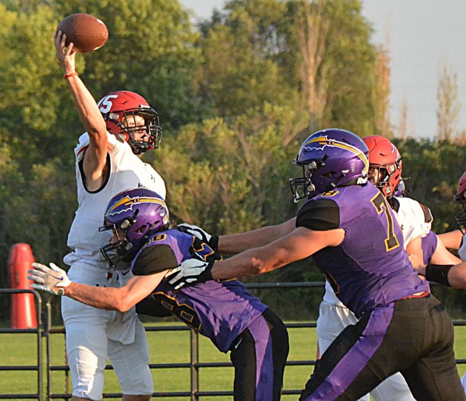 Brookings quarterback Jones Huntimer (15) is hit by Watertown's Kaden Decker as he throws the ball during their season-opening Eastern South Dakota Conference football game on Friday, Aug. 25, 2023 at Watertown Stadium. Also applying pressure is Watertown's Micah Hach (78).