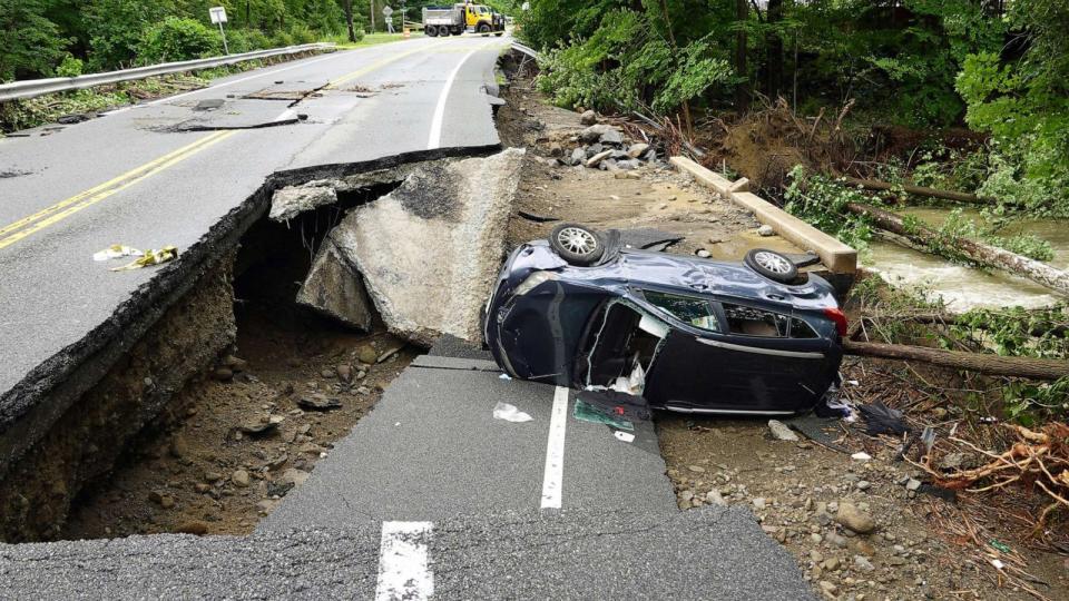 PHOTO: A damaged car lays on a collapsed roadway along Route 32 in the Hudson Valley near Cornwall, N.Y., July 10, 2023. (Paul Kazdan/AP)