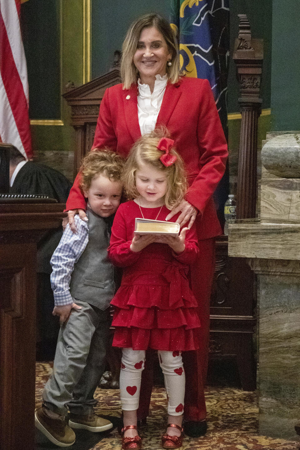 Sen. Kim Ward, poses with her grandchildren Thomas Daniel Ward, 3, and his sister Josie Jane Ward, 4, holding the bible as she took the oath of office as President Pro Tempore of the Pennsylvania Senate, Tuesday, Jan. 3, 2023, in Harrisburg, Pa. (Mark Pynes/The Patriot-News via AP)