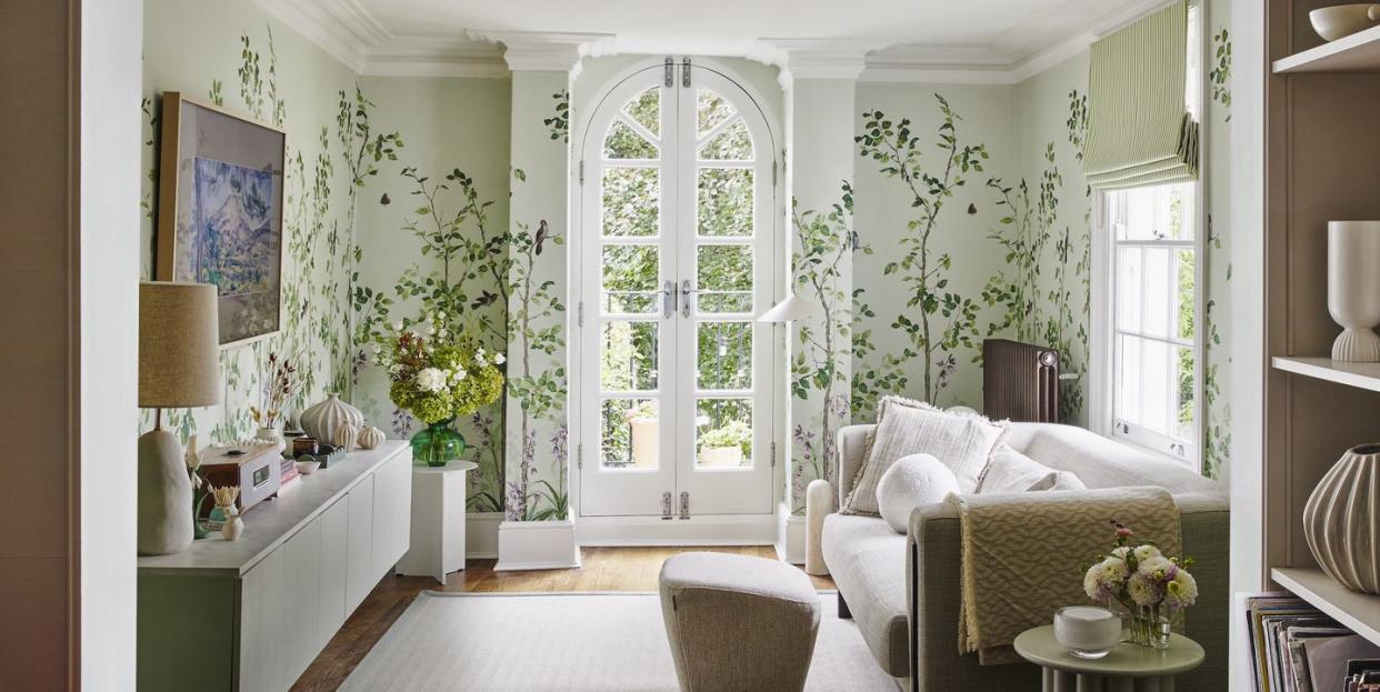 living room in melanie lissacks home with a white french door and botanical wallpaper