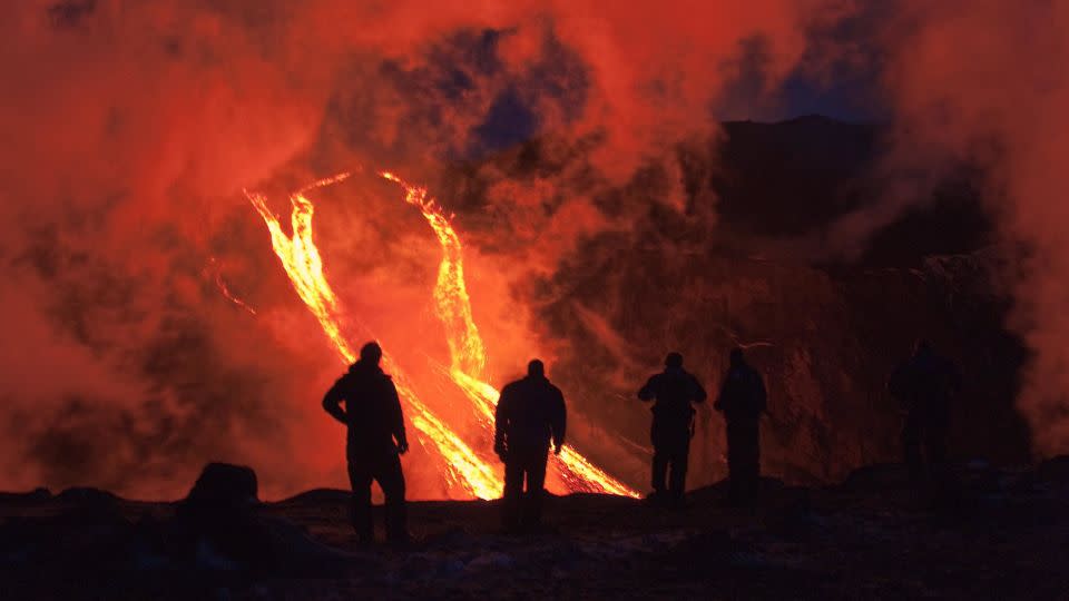 Hikers silhouetted against rivers of lava resulting from a volcanic eruption between Iceland's Myrdalsjokull and Eyjafjallajokull glaciers in March 2010. - NordicPhotos/Getty Images/FILE