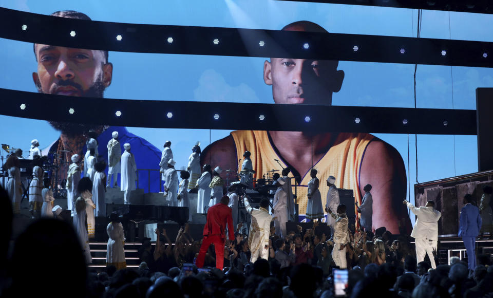 FILE - This Jan. 26, 2020 file photo shows YG, from left, John Legend, Kirk Franklin, DJ Khaled and Meek Mill point to a screen showing Nipsey Hussle and Kobe Bryant during a tribute at the 62nd annual Grammy Awards in Los Angeles. Legend latest release "Bigger Love" comes out Friday, June 19. (Photo by Matt Sayles/Invision/AP, File)