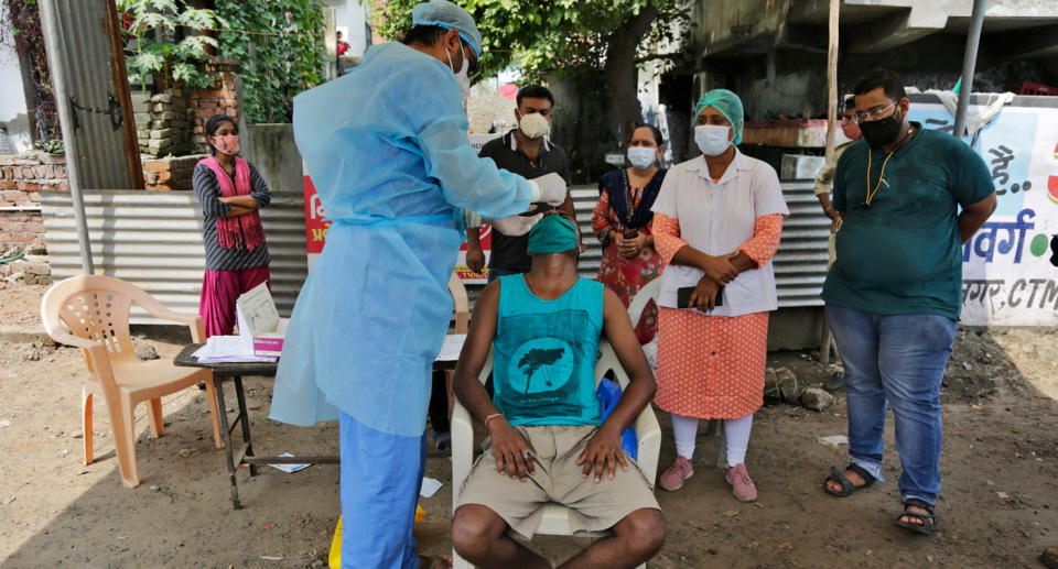 A man is tested for COVID-19 in Ahmedabad on Sunday. Source: AP