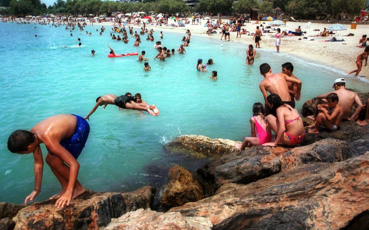 A beach in Greece during normal times. Athens wants a vaccine passport in order to rescue its summer tourism season - THALASSINI DOUMA /AP