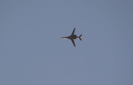 A jet from the U.S.-led coalition flies in the sky over the Syrian town of Kobani as seen from a hill in Tal-Hajeb village that overlooks Kobani, October 7, 2014. REUTERS/Stringer