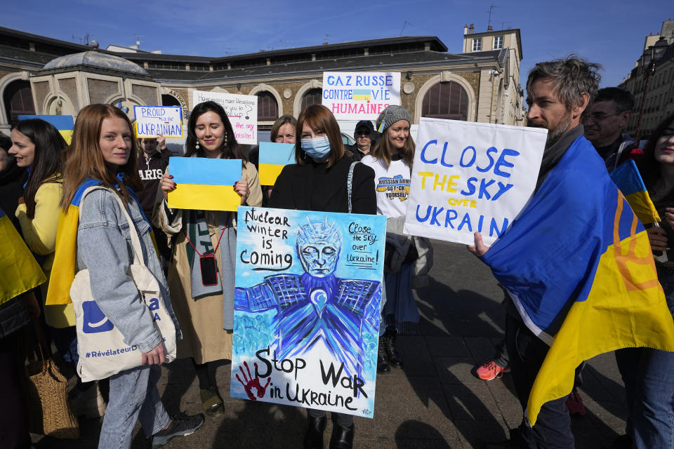 A group of Ukrainian protesters demonstrate near the Chateau de Versailles, where a European Union summit will take place, Thursday, March 10, 2022 in Versailles, west of Paris. With European nations united in backing Ukraine's resistance with unprecedented economic sanctions, three main topics now dominate the agenda: Ukraine's application for fast-track EU membership; how to wean the bloc off its Russian energy dependency; and bolstering the region's defense capabilities. (AP Photo/Michel Euler)