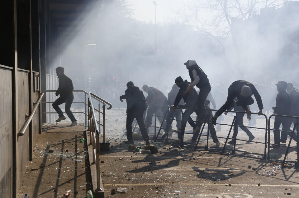 Bosnian protesters prepare to enter a local government building, during a protest, in the Bosnian town of Tuzla, Friday, Feb. 7, 2014. Bosnian protesters stormed and set ablaze local government buildings in three Bosnian cities on Friday in fury over unemployment and rampant corruption. At least 90 people were injured. (AP Photo/Amel Emric)