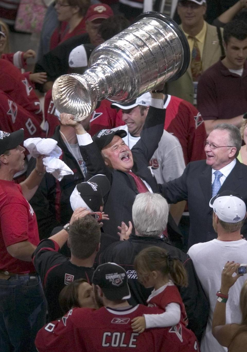 Carolina Hurricanes owner Peter Karmanos hoists the Stanley Cup after the Canes defeated Edmonton 3-1 on Monday June 19, 2006 in Game 7 of the Stanley Cup finals. stf/Robert Willett