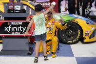 Kyle Busch has water poured on him by his son, Brexton, after winning a NASCAR Xfinity Series auto race at Nashville Superspeedway Saturday, June 19, 2021, in Lebanon, Tenn. (AP Photo/Mark Humphrey)