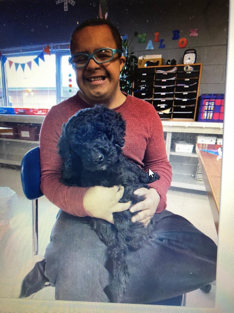 Ben Mumbai and Rocky have formed a close relationship since the goldendoodle became part of Tammie Radican's classroom at Plymouth High School.