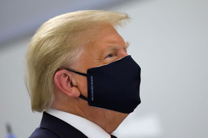 U.S. President Donald Trump wears a protective face mask during a tour of the Fujifilm Diosynth Biotechnologies' Innovation Center, in Morrisville