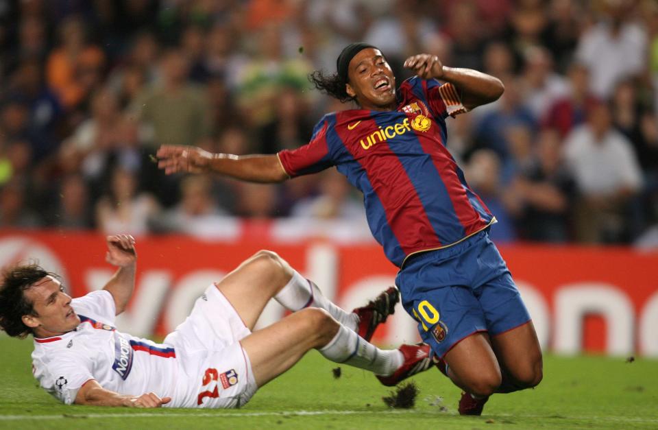 Barcelona's Ronaldinho struggles against the Olympique Lyonnais defence of Sebastien Squillaci