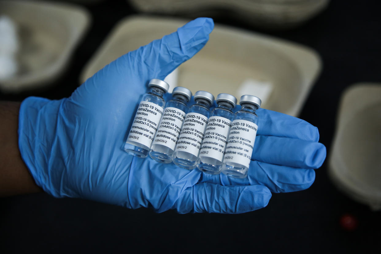 LONDON, UNITED KINGDOM - 2021/05/01: A Covid-19 vaccinator holds vials containing Oxford/AstraZeneca Covid-19 vaccine at a medical centre being used as vaccination centre in north London. (Photo by Dinendra Haria/SOPA Images/LightRocket via Getty Images)