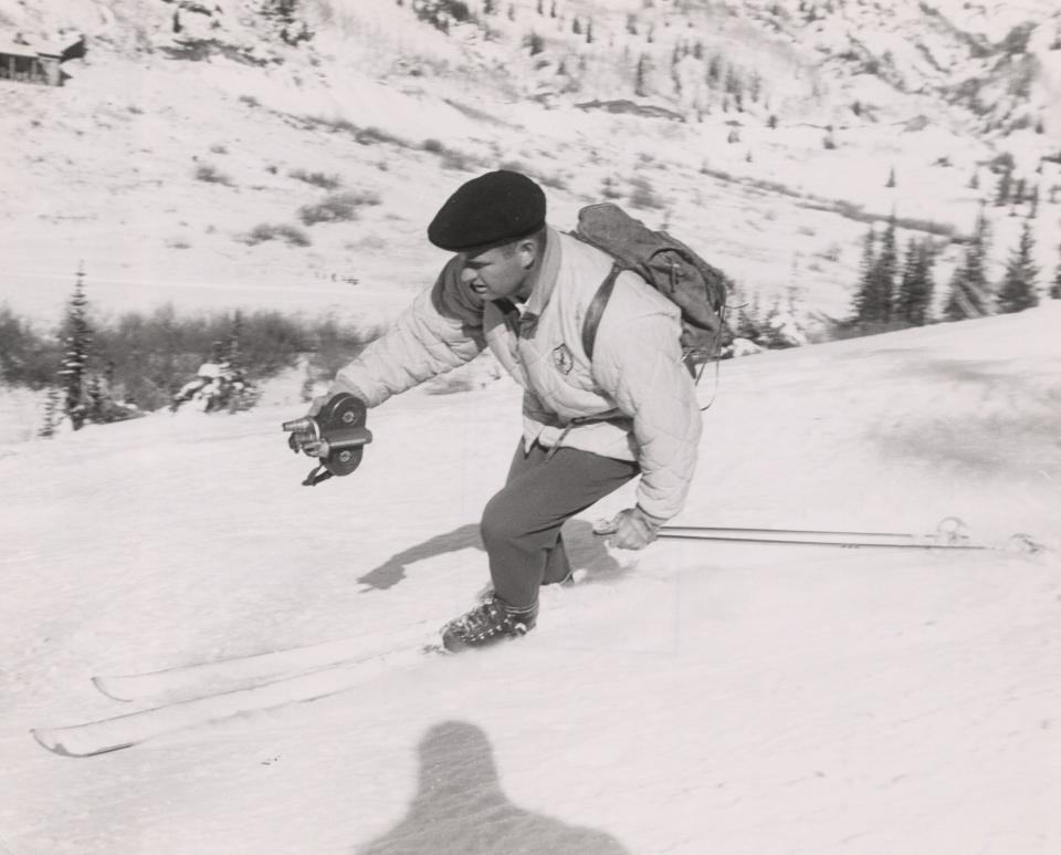 The late Warren Miller films on a slope decades ago, creating one his legendary ski films.