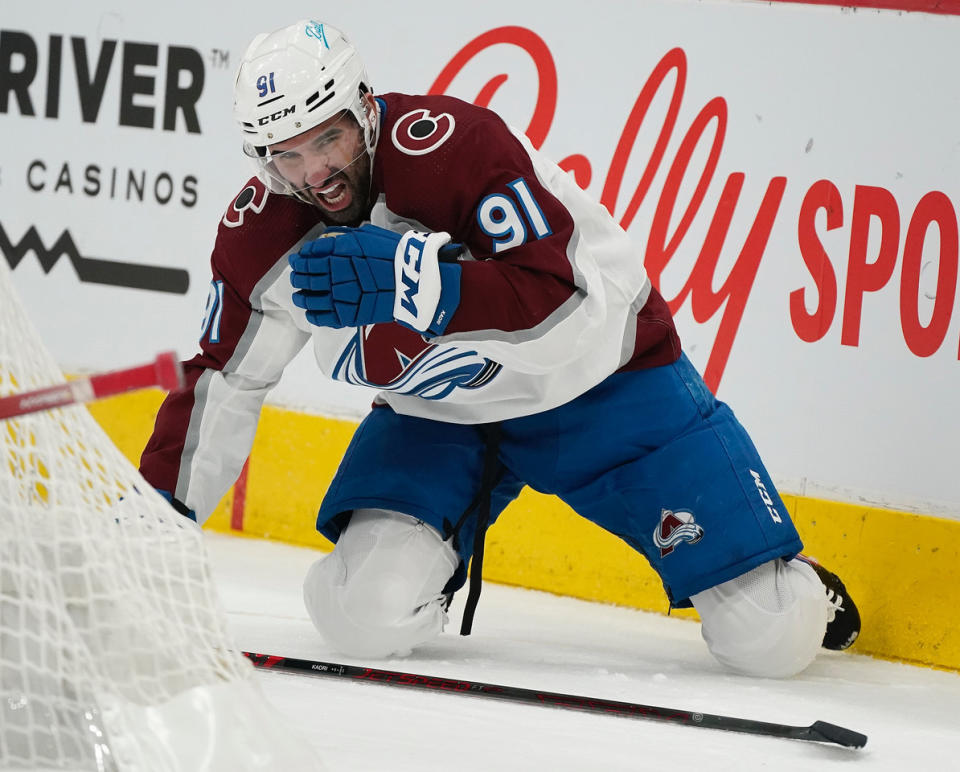 Colorado Avalanche's Name Kadri (91) reacts after getting hit by a high stick from Arizona Coyotes' Ilya Lyubshkin during the first period of an NHL hockey game Saturday, Jan. 15, 2022, in Glendale, Ariz. (AP Photo/Darryl Webb)