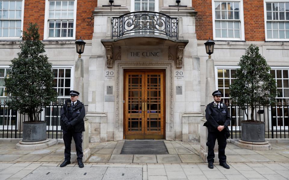 Police officers stand outside The London Clinic where the Princess of Wales is recovering postoperation