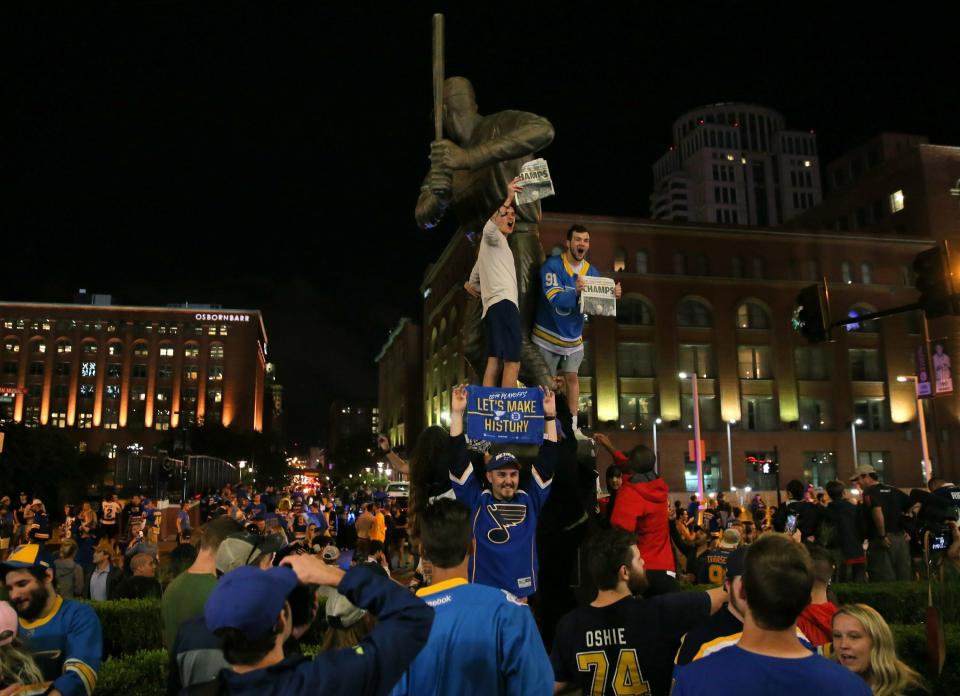 St. Louis Blues fans celebrate the team's win against the Boston Bruins in Game 7 of the NHL hockey Stanley Cup Final in Boston, outside Busch Stadium in St. Louis after a watch party for the game was held in the baseball stadium Wednesday, June 12, 2019. (David Carson/St. Louis Post-Dispatch via AP)