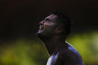 A wrestler celebrates as he competes during the 661st annual Historic Kirkpinar Oil Wrestling championship, in Edirnee, northwestern Turkey, Saturday, July 2, 2022. The festival is part of UNESCO's List of Intangible Cultural Heritages. (AP Photo/Francisco Seco)